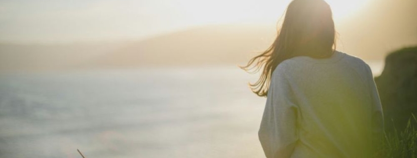 lady looking at beach sunset