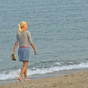 lady with long sleeve top short skirt walking at beach clear day lady walking at the beach